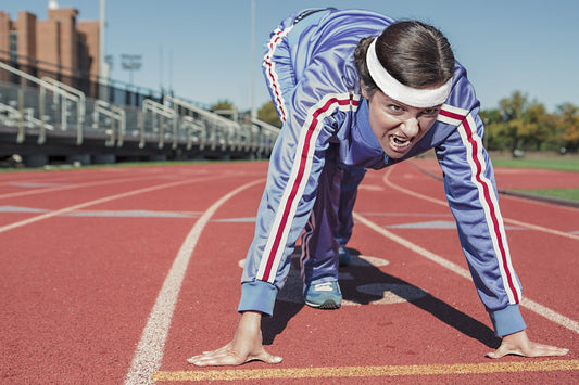 Woman with headband at starting line on track